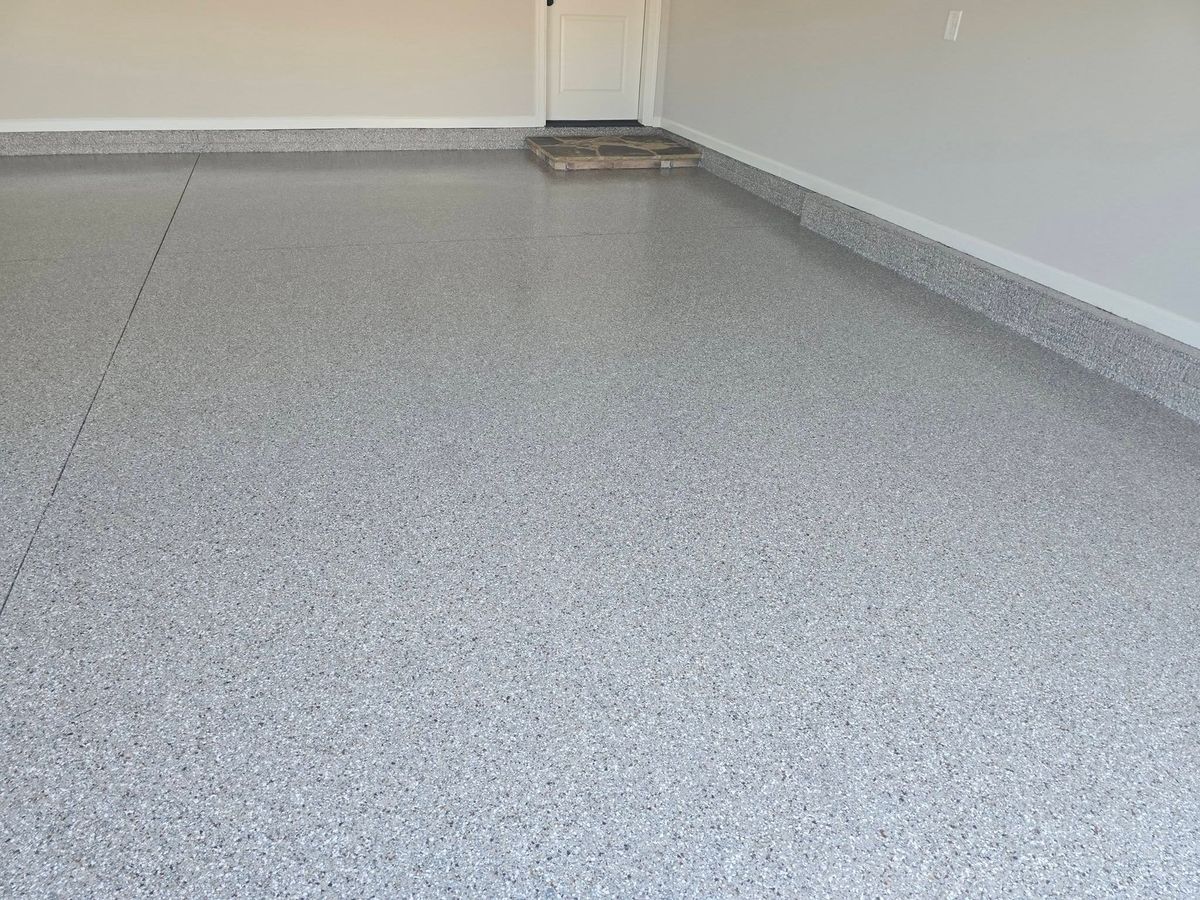 Flake epoxy garage floor in front of an interior door