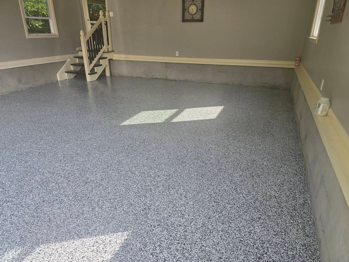 Gray flake epoxy floor at the foot of the garage stairs
