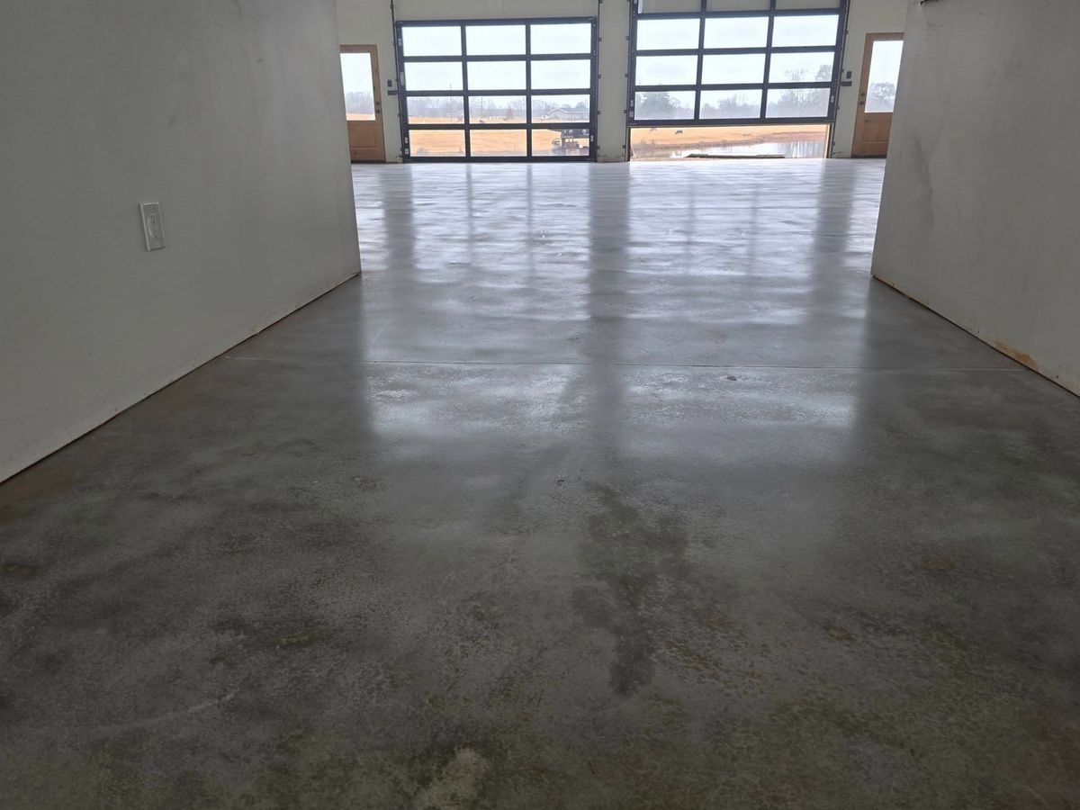 Open roll-up door lighting a polished concrete garage floor