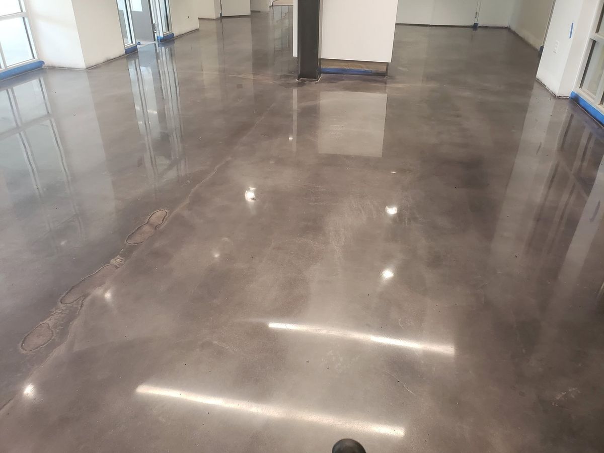 Overhead lights reflected in a high-gloss polished concrete floor