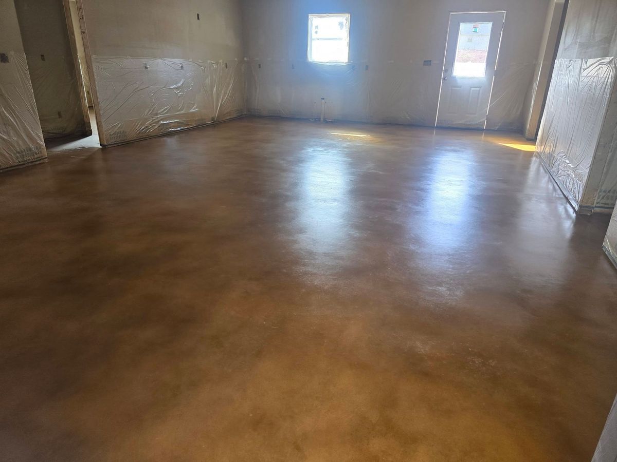 Empty room with a warm brown stained and sealed concrete floor