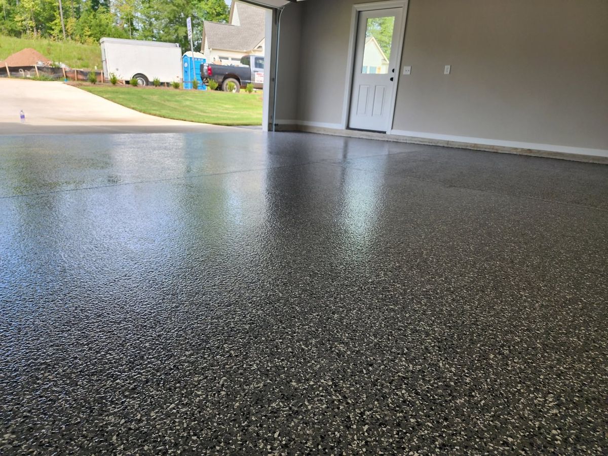 Gray flake epoxy garage floor looking out at a new subdivision