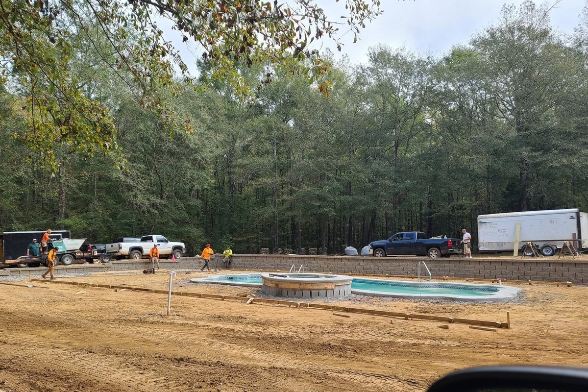 Pool deck being formed for a new pour with the crew trucks parked behind