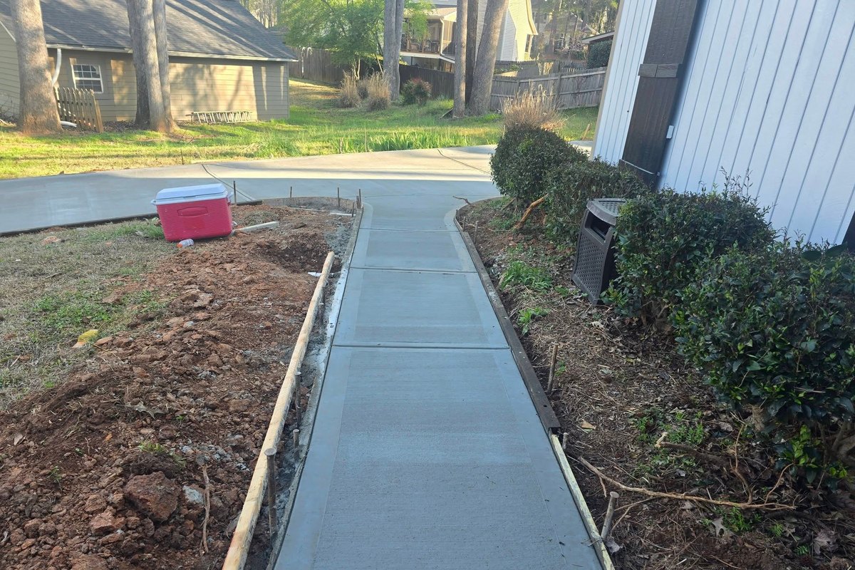 Replaced concrete walkway between a house and its landscaping