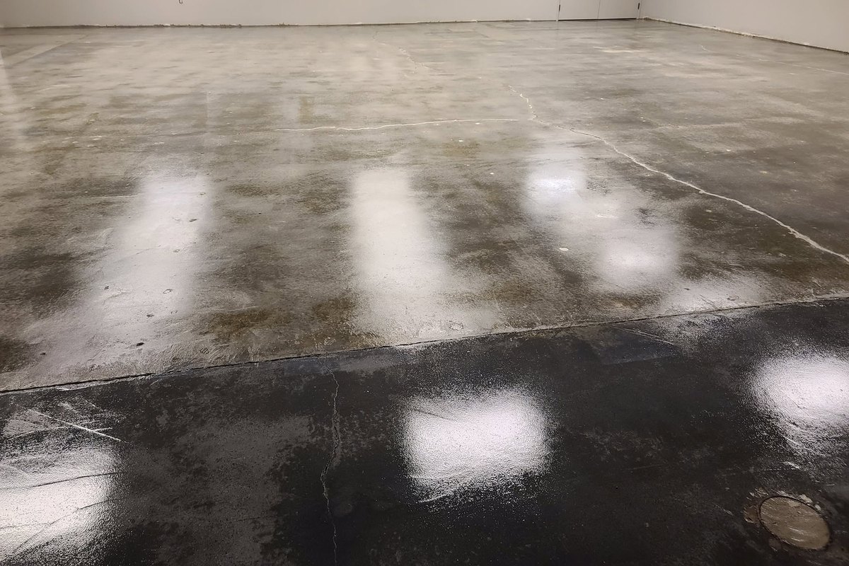 Freshly resurfaced concrete floor still wet from the finish coat