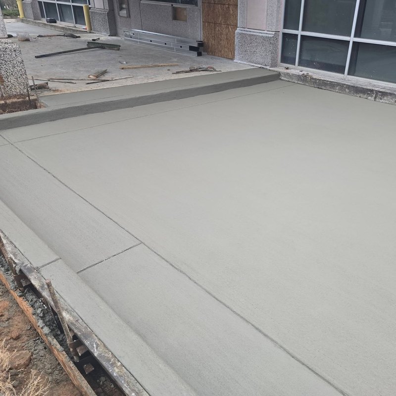 Wide commercial slab pour finished up to a window wall