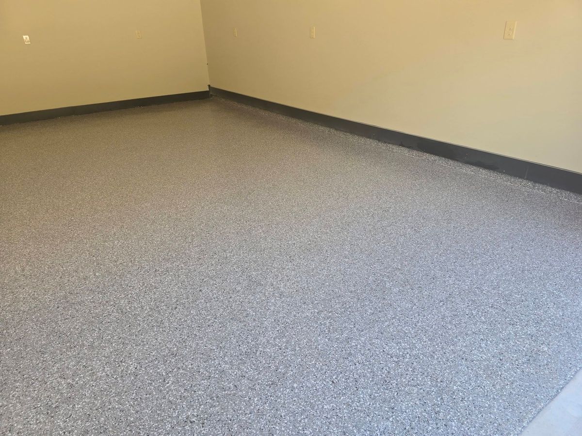 Clean gray flake epoxy floor in an empty garage