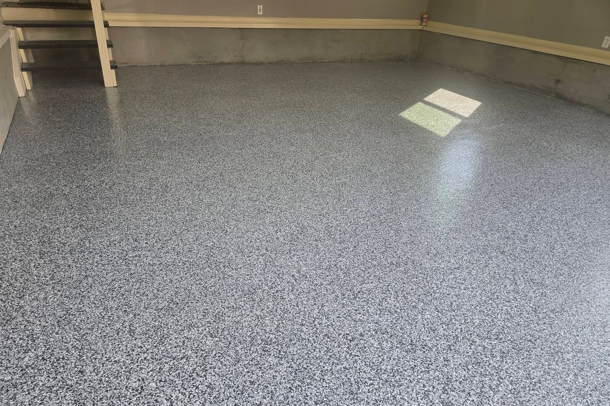Flake epoxy garage floor lit by a window