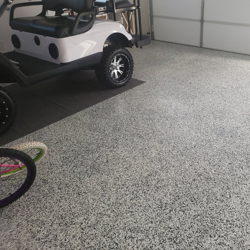 Golf cart parked on a new flake epoxy garage floor