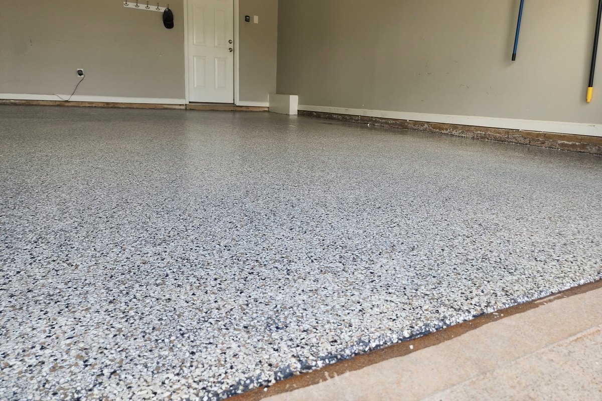 Gray flake epoxy floor in an empty garage