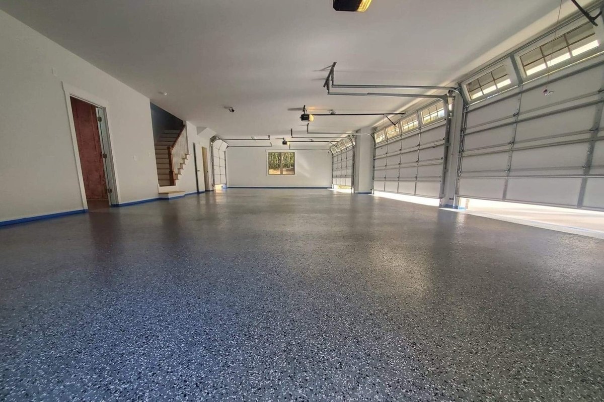 Three-car garage with a gray flake epoxy floor