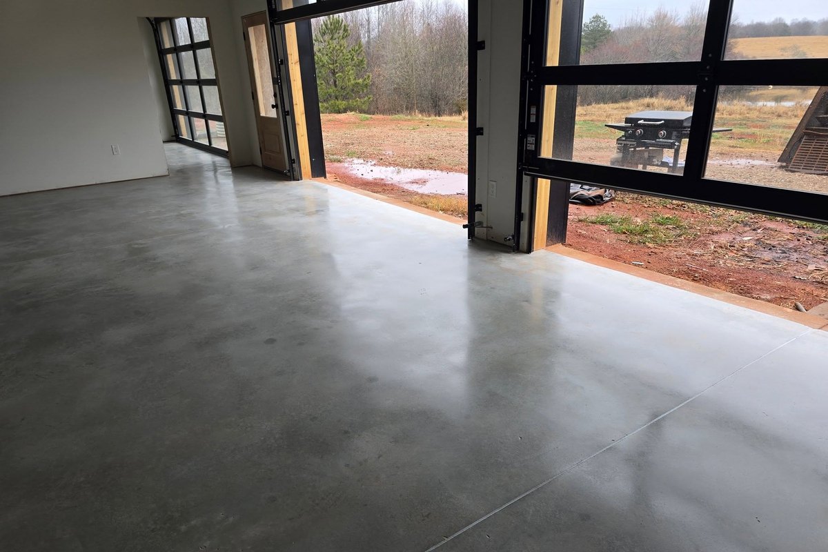 Polished concrete garage floor with both bay doors open to the driveway