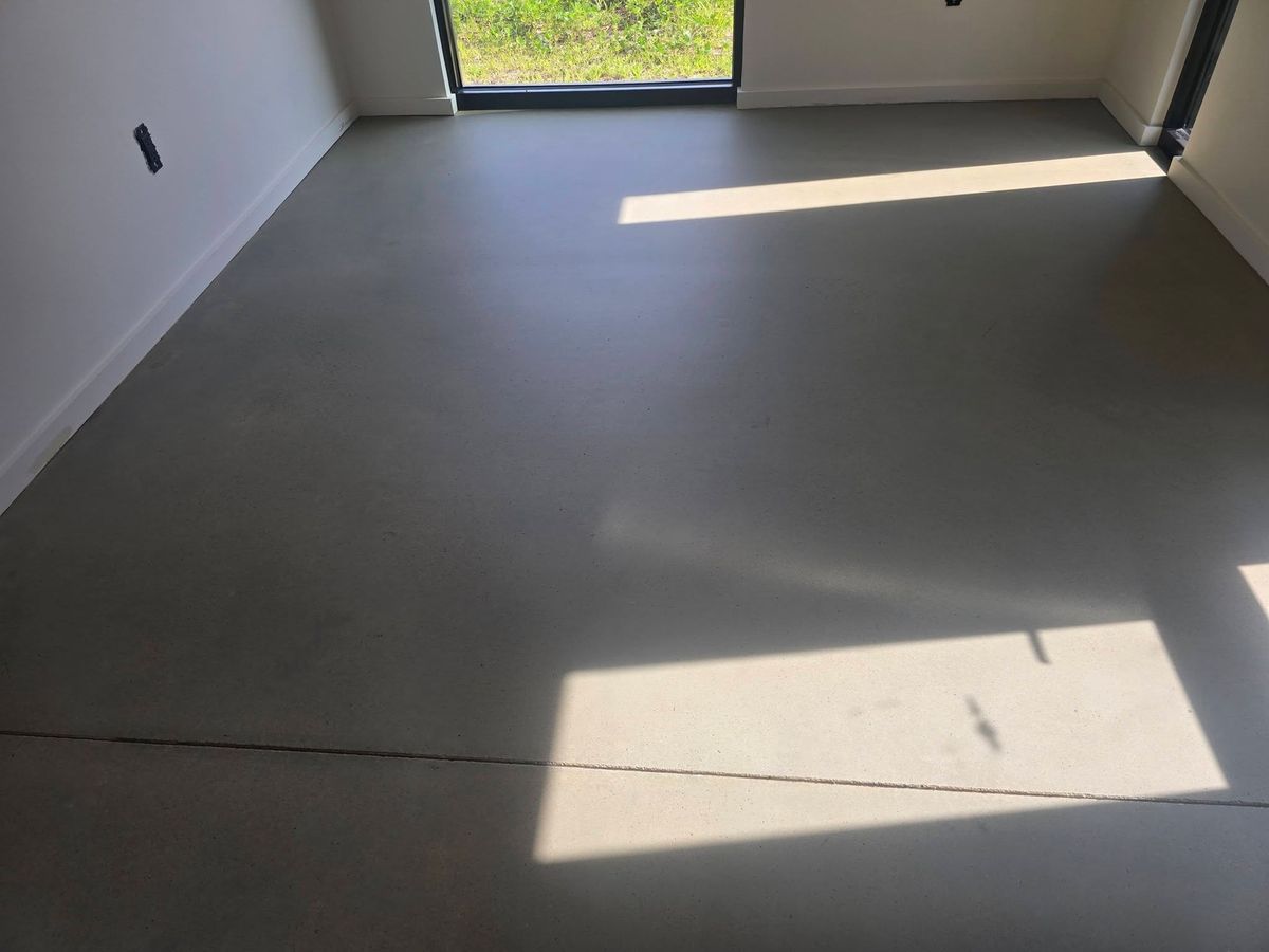 Sunlit polished concrete floor in a bare room