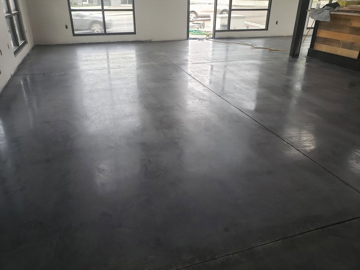 Polished shop floor lit by a wall of windows