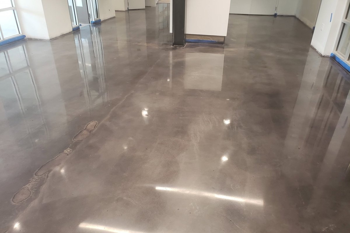 High-gloss polished concrete floor reflecting the overhead lights
