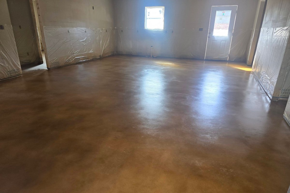 Warm brown stained and sealed concrete floor in an empty room